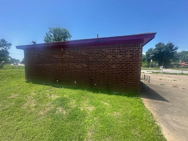 8008 De Priest St, Houston, TX 77088 - view of side of home with a yard and brick siding