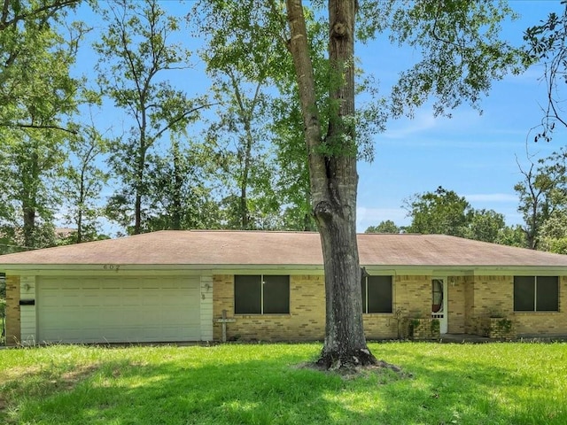 602 Devereaux St, Diboll, TX 75941 - single story home with brick siding, a front lawn, and an attached garage