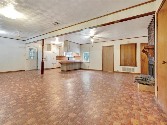 602 Devereaux St, Diboll, TX 75941 - unfurnished living room with a ceiling fan and a fireplace