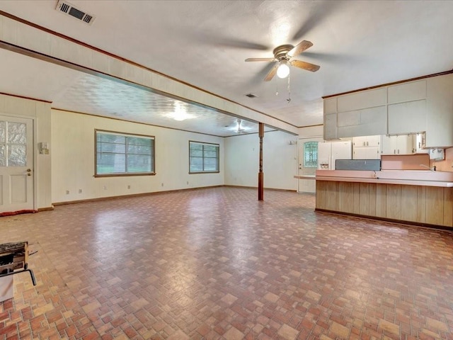 602 Devereaux St, Diboll, TX 75941 - unfurnished living room featuring a ceiling fan and baseboards