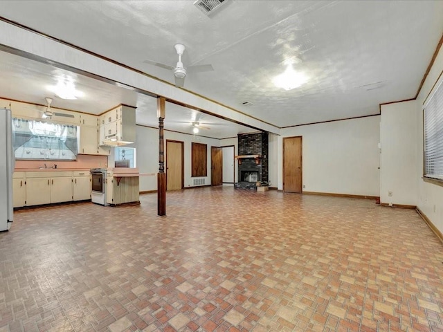 602 Devereaux St, Diboll, TX 75941 - unfurnished living room with a ceiling fan and brick patterned flooring
