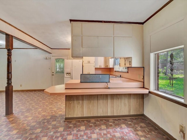 602 Devereaux St, Diboll, TX 75941 - kitchen with white refrigerator with ice dispenser, a peninsula, ornamental molding, and light countertops
