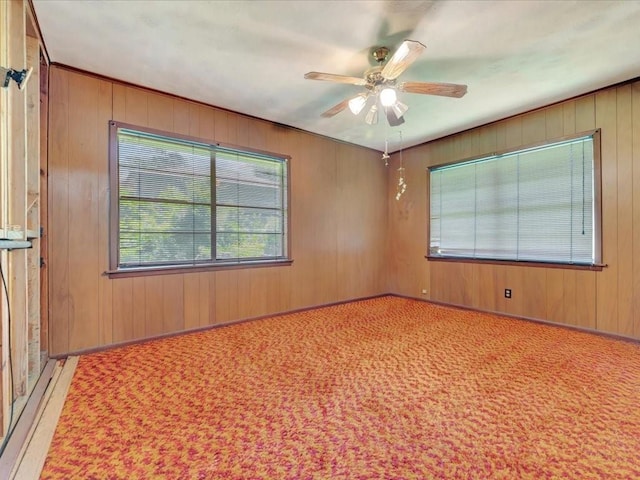 602 Devereaux St, Diboll, TX 75941 - spare room with ceiling fan, wooden walls, and carpet