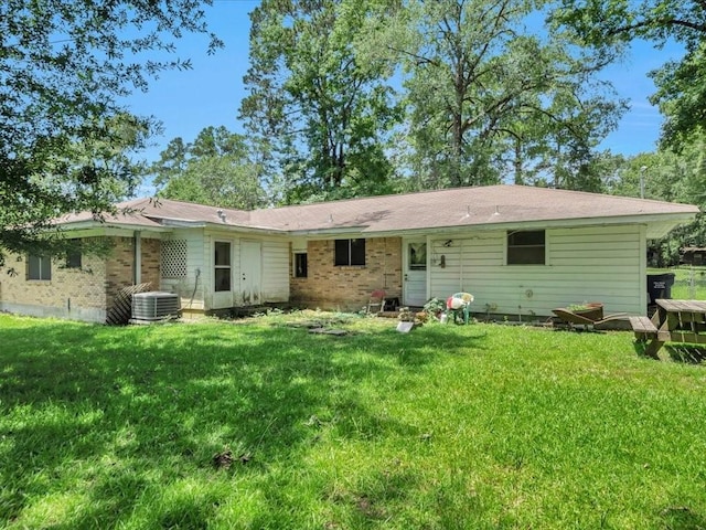 602 Devereaux St, Diboll, TX 75941 - rear view of house with a lawn and brick siding