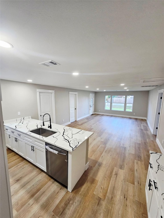5014 Middleton St, Baytown, TX 77520 - kitchen featuring stainless steel dishwasher, light wood-style flooring, white cabinetry, and recessed lighting