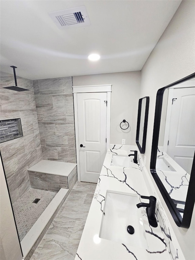 5014 Middleton St, Baytown, TX 77520 - bathroom featuring marble look tiles, double vanity, and a tile shower