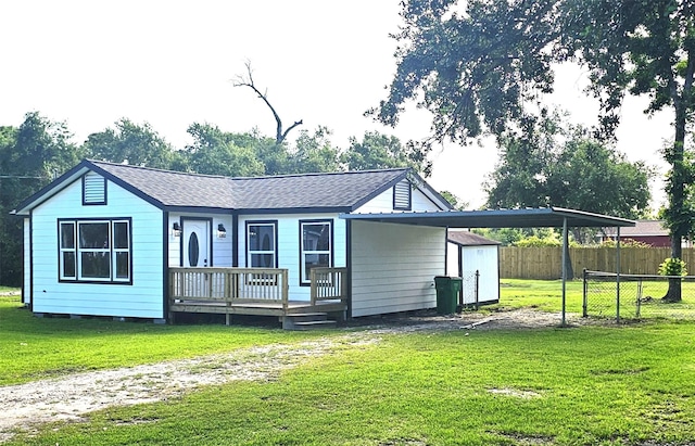 5014 Middleton St, Baytown, TX 77520 - back of house featuring a carport, roof with shingles, a porch, and driveway