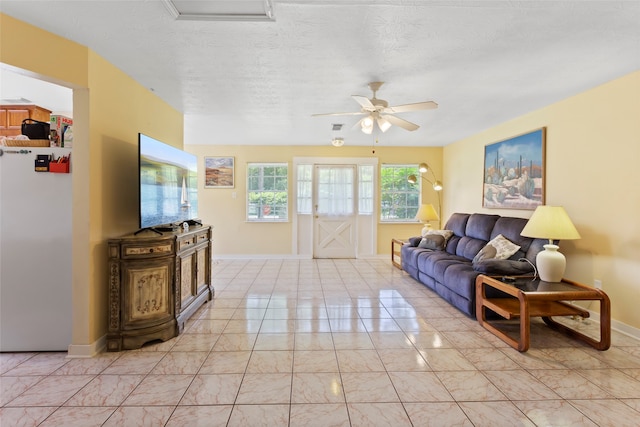 4444 18th St, Bacliff, TX 77518 - living area with ceiling fan, light marble finish floors, and a textured ceiling
