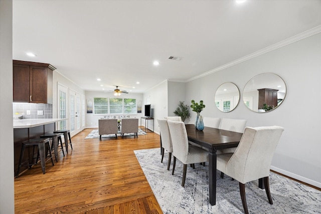 4614 Kinglet St, Houston, TX 77035 - dining area featuring light wood-style flooring, a ceiling fan, crown molding, and recessed lighting