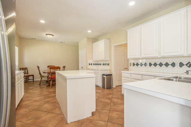 2521 Sea Horse Ct, Seabrook, TX 77586 - kitchen featuring a kitchen island, backsplash, recessed lighting, light tile patterned floors, and freestanding refrigerator