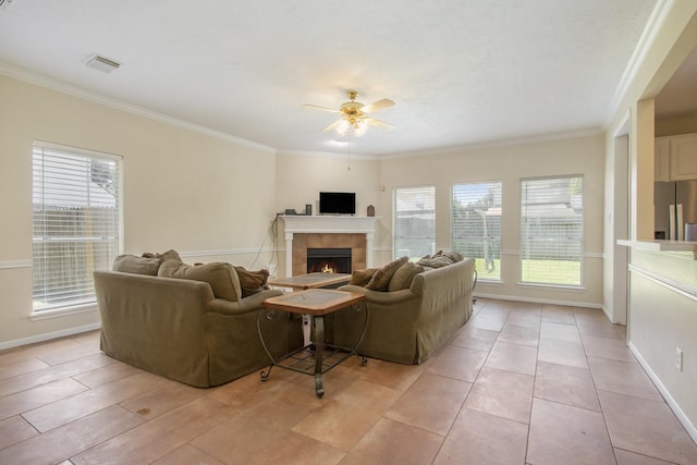 2521 Sea Horse Ct, Seabrook, TX 77586 - living room with ceiling fan, ornamental molding, and a tiled fireplace