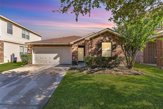 10515 Kentington Oak Dr, Humble, TX 77396 - view of front of home featuring driveway, an attached garage, a lawn, and brick siding