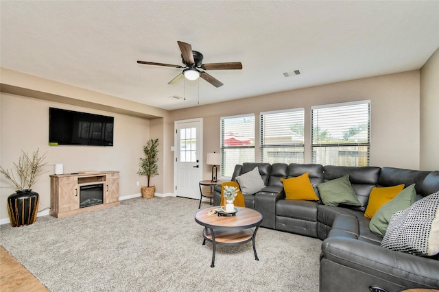 10515 Kentington Oak Dr, Humble, TX 77396 - living room with ceiling fan and a premium fireplace