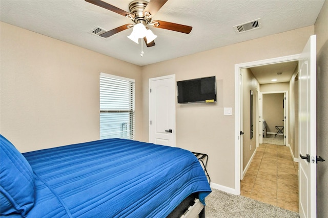 10515 Kentington Oak Dr, Humble, TX 77396 - bedroom featuring ceiling fan, light tile patterned floors, and light colored carpet