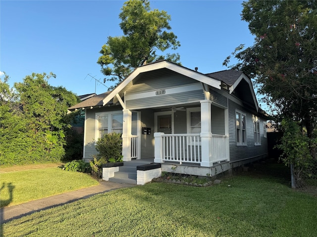 110 E 24th St, Houston, TX 77008 - view of front of home featuring a porch, a front yard, and a shingled roof