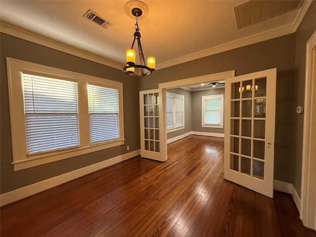 110 E 24th St, Houston, TX 77008 - spare room featuring crown molding, dark wood finished floors, and a chandelier