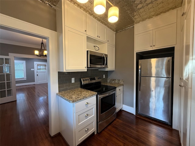 110 E 24th St, Houston, TX 77008 - kitchen with appliances with stainless steel finishes, an ornate ceiling, white cabinets, dark wood finished floors, and light stone counters