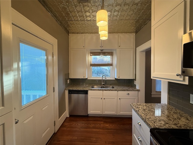 110 E 24th St, Houston, TX 77008 - kitchen featuring stainless steel appliances, an ornate ceiling, tasteful backsplash, dark wood-type flooring, and white cabinetry