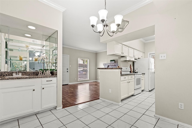 2425 Augusta Dr Unit 30, Houston, TX 77057 - kitchen with white appliances, crown molding, under cabinet range hood, white cabinets, and a chandelier