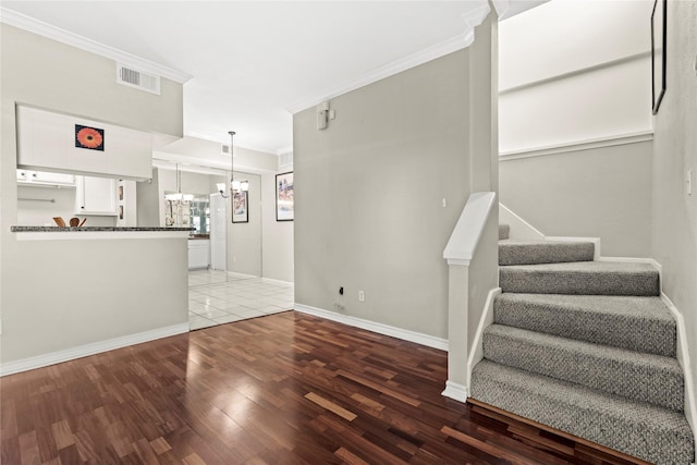 2425 Augusta Dr Unit 30, Houston, TX 77057 - unfurnished living room featuring a chandelier, wood finished floors, ornamental molding, and stairway
