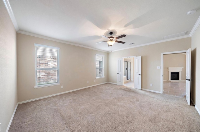 2 Painted Post Pl, Spring, TX 77389 - unfurnished bedroom with light carpet, multiple windows, crown molding, a glass covered fireplace, and a ceiling fan
