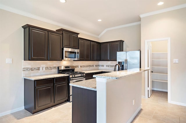 2 Painted Post Pl, Spring, TX 77389 - kitchen featuring stainless steel appliances, tasteful backsplash, an island with sink, light stone counters, and ornamental molding