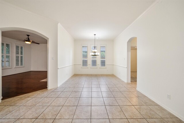 47 Dresden Pl, The Woodlands, TX 77382 - unfurnished room featuring a ceiling fan, crown molding, a chandelier, light tile patterned flooring, and arched walkways