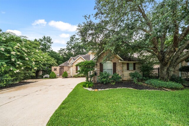 47 Dresden Pl, The Woodlands, TX 77382 - view of front of property with stone siding and driveway