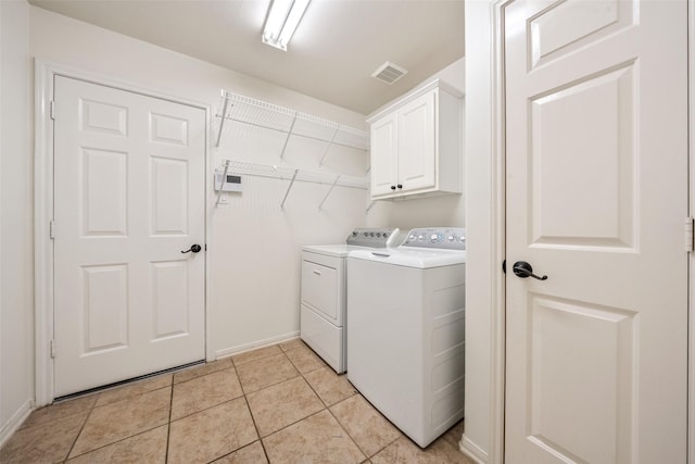 47 Dresden Pl, The Woodlands, TX 77382 - washroom with washing machine and clothes dryer, cabinet space, and light tile patterned floors