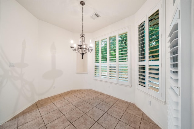 47 Dresden Pl, The Woodlands, TX 77382 - spare room featuring a chandelier and light tile patterned floors