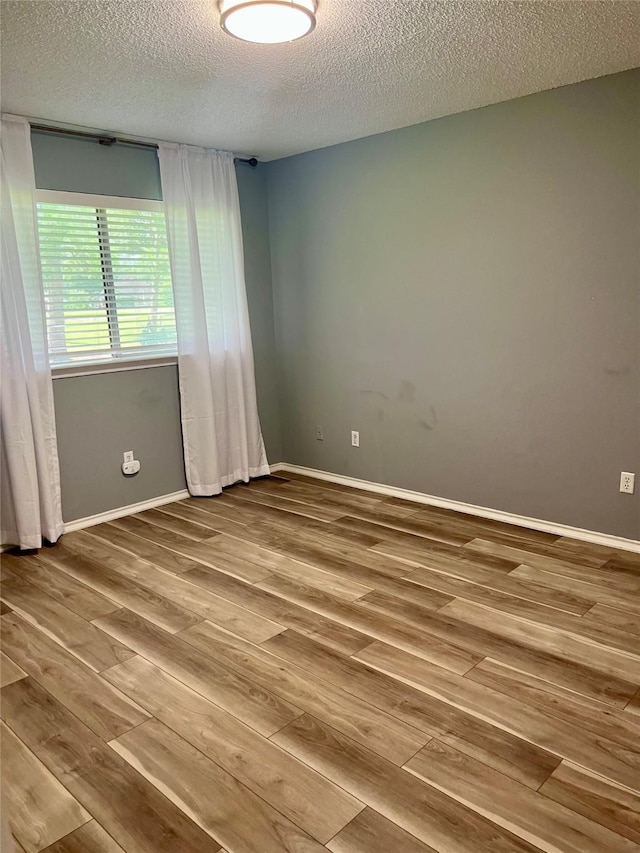 667 E Country Grove Cir, Pearland, TX 77584 - unfurnished room featuring a textured ceiling and wood finished floors