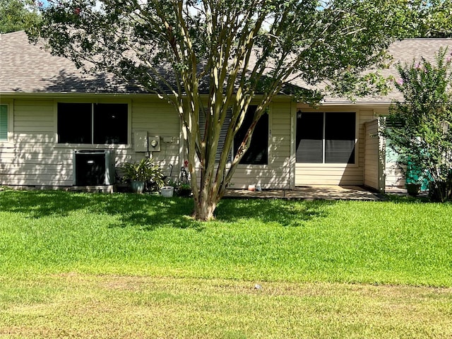 667 E Country Grove Cir, Pearland, TX 77584 - back of house with a yard, a shingled roof, and a patio