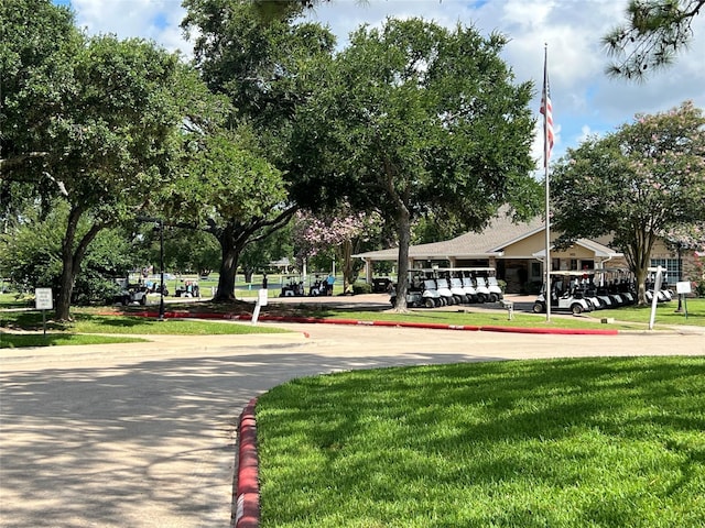 667 E Country Grove Cir, Pearland, TX 77584 - view of home's community with a lawn and uncovered parking