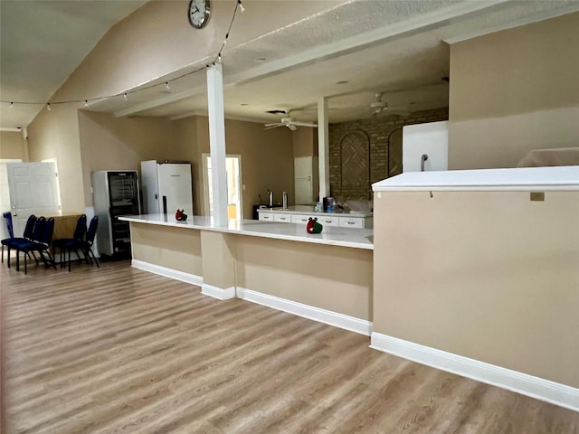 667 E Country Grove Cir, Pearland, TX 77584 - kitchen with light wood-type flooring, a ceiling fan, freestanding refrigerator, open floor plan, and light countertops