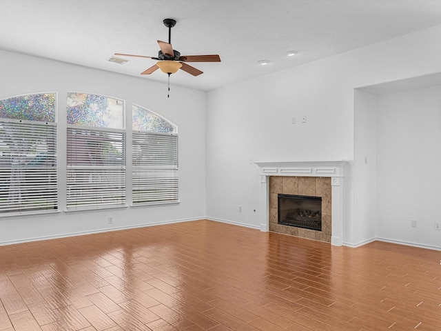 11702 Park Cedar Ct, Tomball, TX 77377 - unfurnished living room with a ceiling fan, a tile fireplace, wood finished floors, and recessed lighting