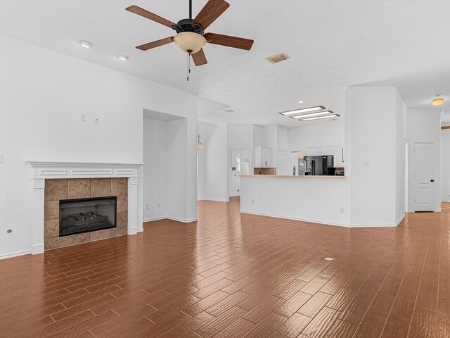 11702 Park Cedar Ct, Tomball, TX 77377 - unfurnished living room featuring wood finished floors, a ceiling fan, a fireplace, and recessed lighting