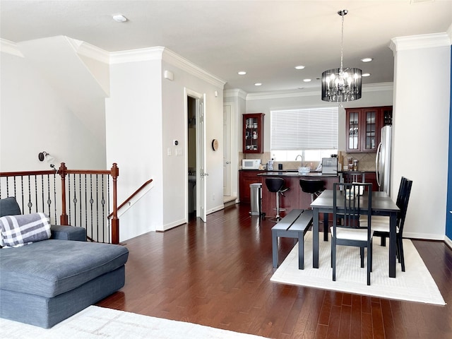3207 Clearview Cir, Houston, TX 77025 - dining space featuring dark wood-style floors, a chandelier, crown molding, and recessed lighting