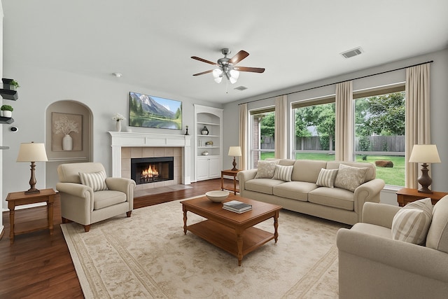 17518 Cypress Laurel St, Houston, TX 77095 - living area with plenty of natural light, a ceiling fan, wood finished floors, and a fireplace