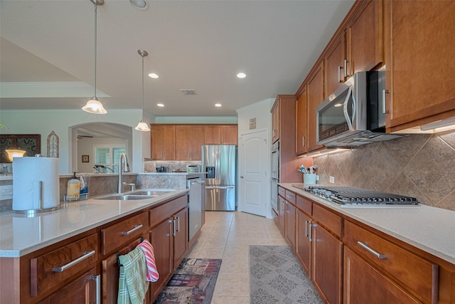 3903 Grand Fir Ct, Richmond, TX 77469 - kitchen with stainless steel appliances, crown molding, brown cabinets, tasteful backsplash, and recessed lighting