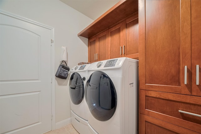 3903 Grand Fir Ct, Richmond, TX 77469 - washroom with washer and clothes dryer, cabinet space, and light tile patterned floors