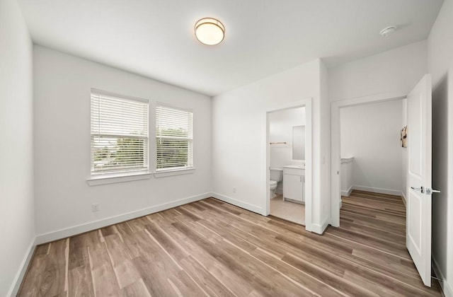 3506 Dorset Cliff Ln, Houston, TX 77055 - unfurnished bedroom featuring light wood-style flooring and connected bathroom