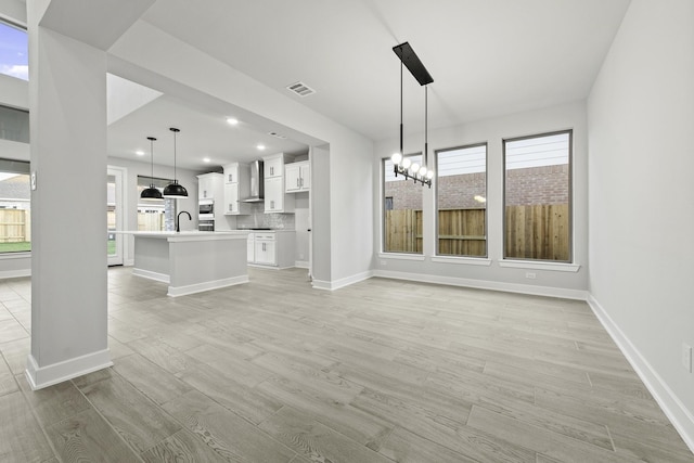 3240 Stingray Cove Dr, Katy, TX 77493 - unfurnished living room featuring light wood finished floors, a chandelier, and recessed lighting