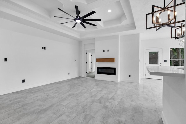 3220 Saint James Blvd, Beaumont, TX 77705 - unfurnished living room with a raised ceiling, a chandelier, a glass covered fireplace, recessed lighting, and a ceiling fan
