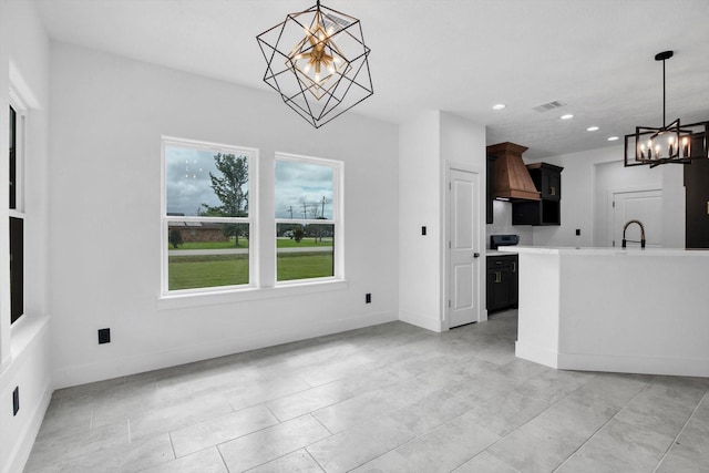 3220 Saint James Blvd, Beaumont, TX 77705 - kitchen with a chandelier, custom exhaust hood, recessed lighting, light countertops, and hanging light fixtures