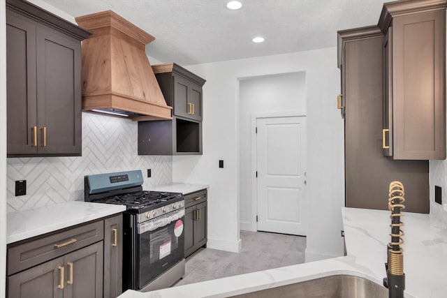 3220 Saint James Blvd, Beaumont, TX 77705 - kitchen featuring stainless steel gas range oven, custom range hood, light stone countertops, tasteful backsplash, and recessed lighting