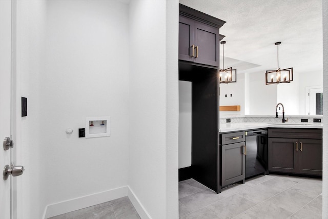 3220 Saint James Blvd, Beaumont, TX 77705 - washroom featuring a chandelier, light tile patterned flooring, and washer hookup