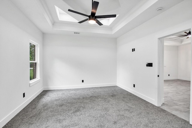 3220 Saint James Blvd, Beaumont, TX 77705 - carpeted spare room with a tray ceiling, a ceiling fan, a smoke detector, a skylight, and ornamental molding