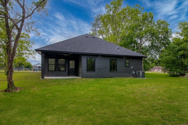 3220 Saint James Blvd, Beaumont, TX 77705 - rear view of house with a ceiling fan, a shingled roof, a lawn, and a patio