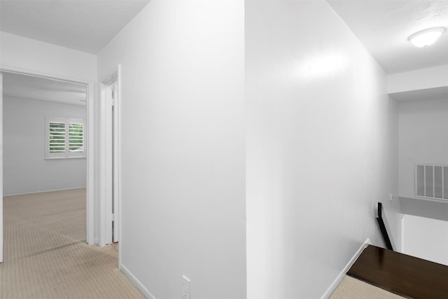 310 W Fair Harbor Ln, Houston, TX 77079 - corridor featuring light colored carpet and an upstairs landing