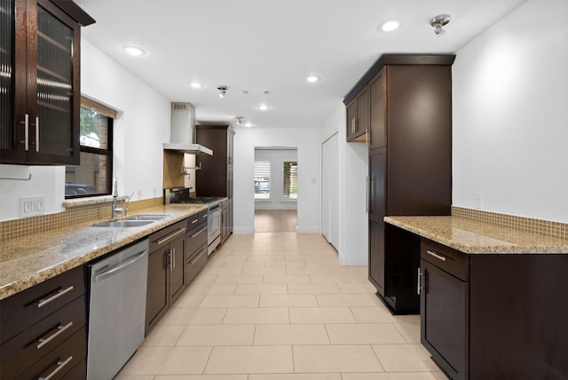 310 W Fair Harbor Ln, Houston, TX 77079 - kitchen featuring exhaust hood, appliances with stainless steel finishes, light stone counters, dark brown cabinets, and recessed lighting